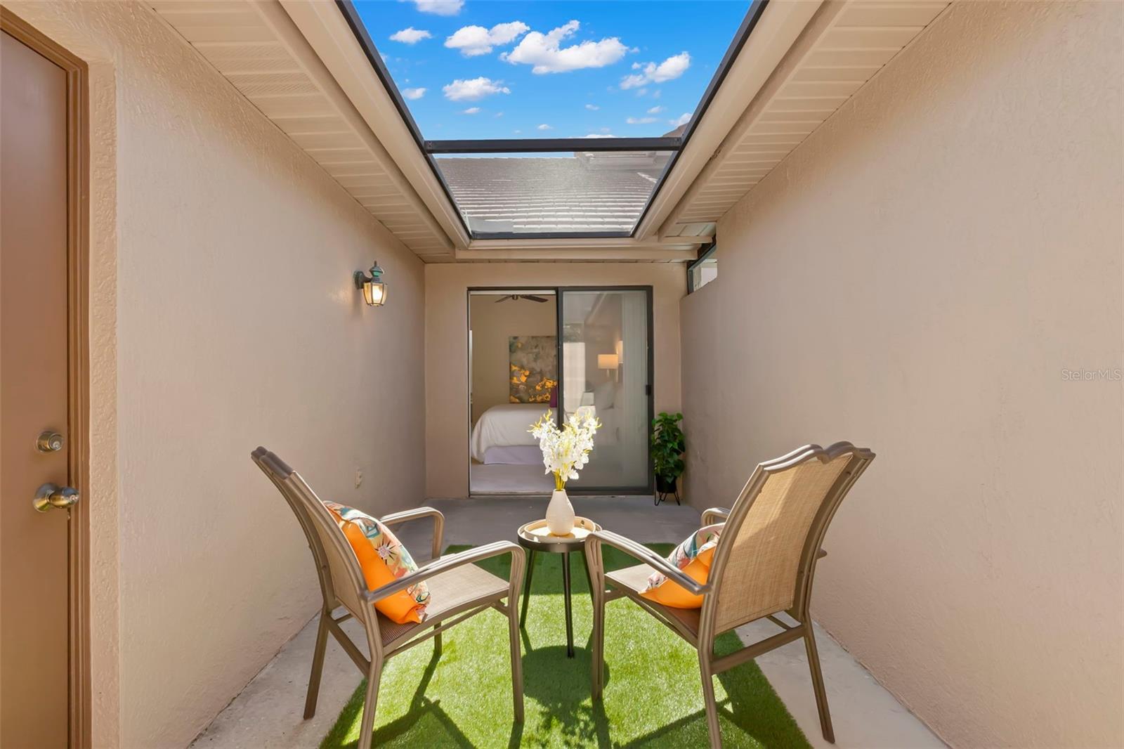 A little lanai outside the Primary Bedroom, ready to relax and enjoy the sun.