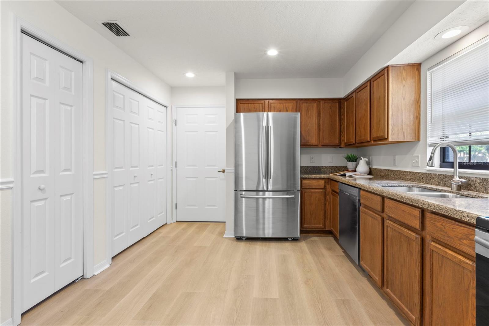 kitchen, to the left of fridge is laundry