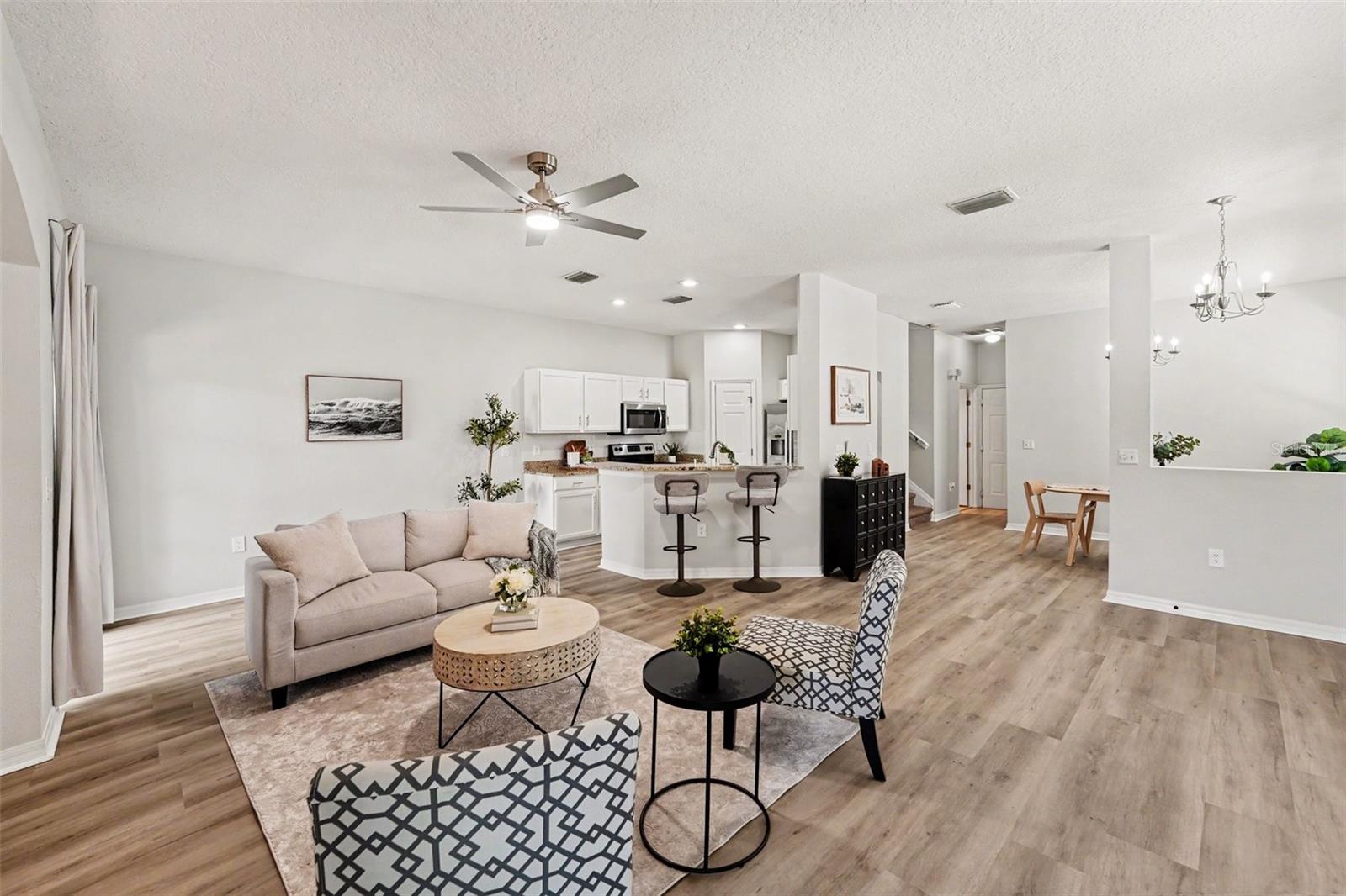 Living room view, with LVP floors and spacious eat-in kitchen