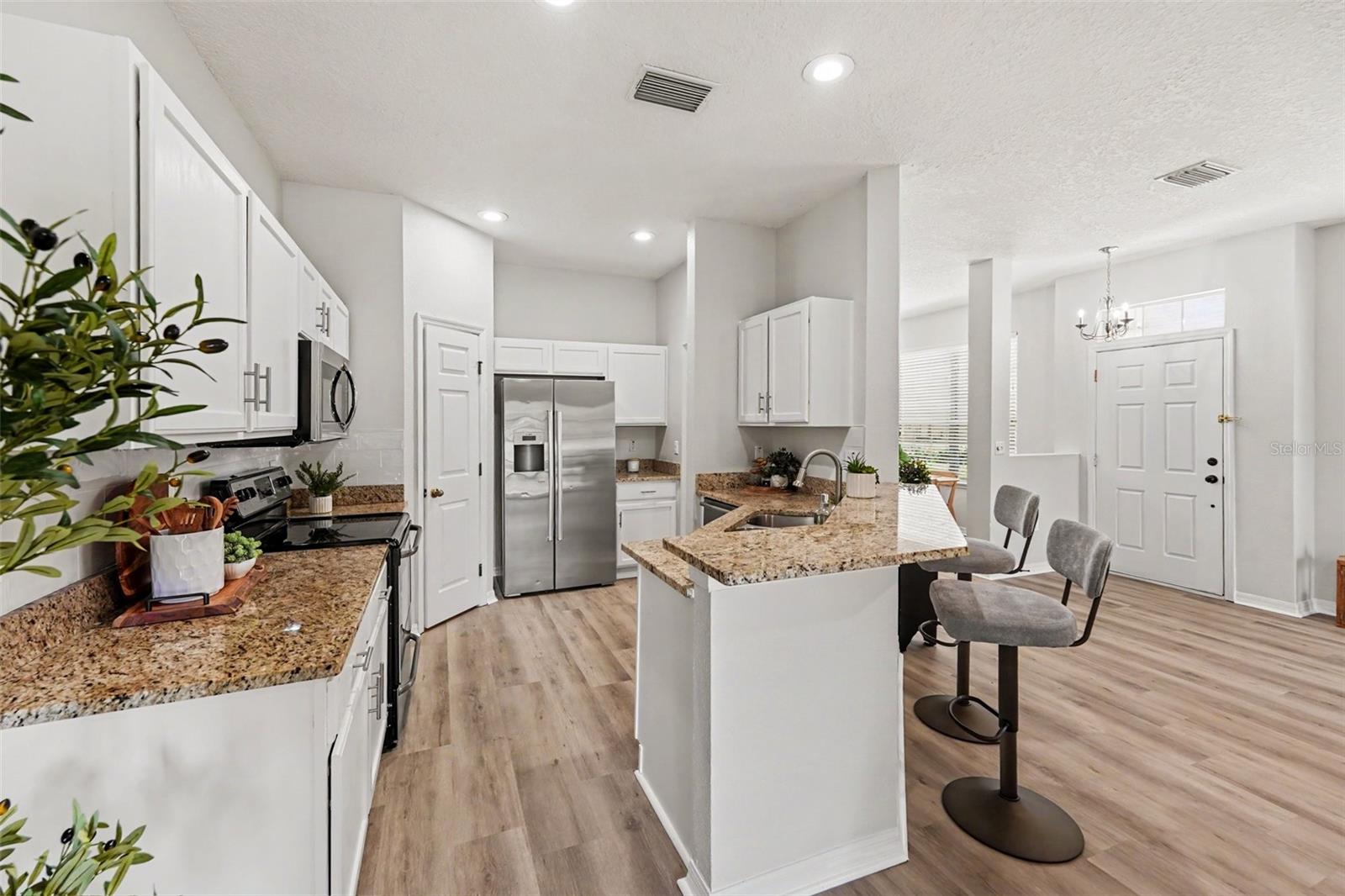 Spacious kitchen with walk-in pantry and stainless steel appliances