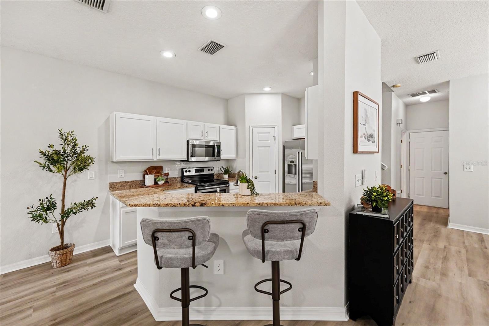 Eat in kitchen space, fits one more chair!