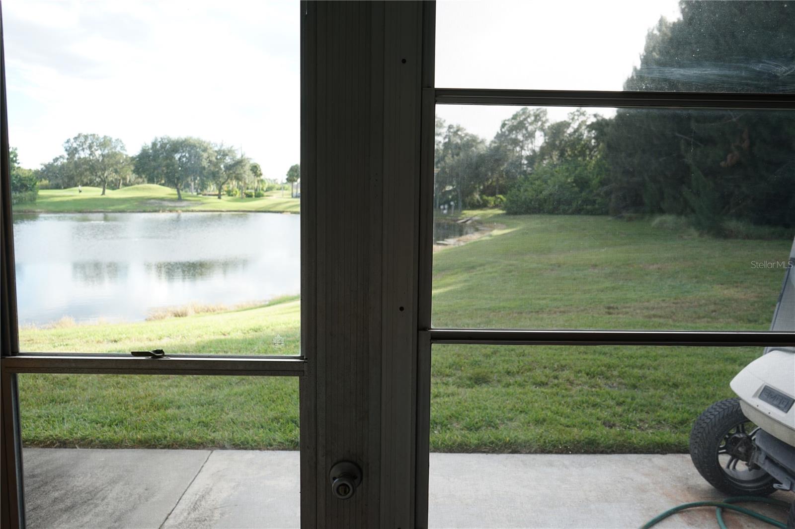 lanai has glass windows and a pond view
