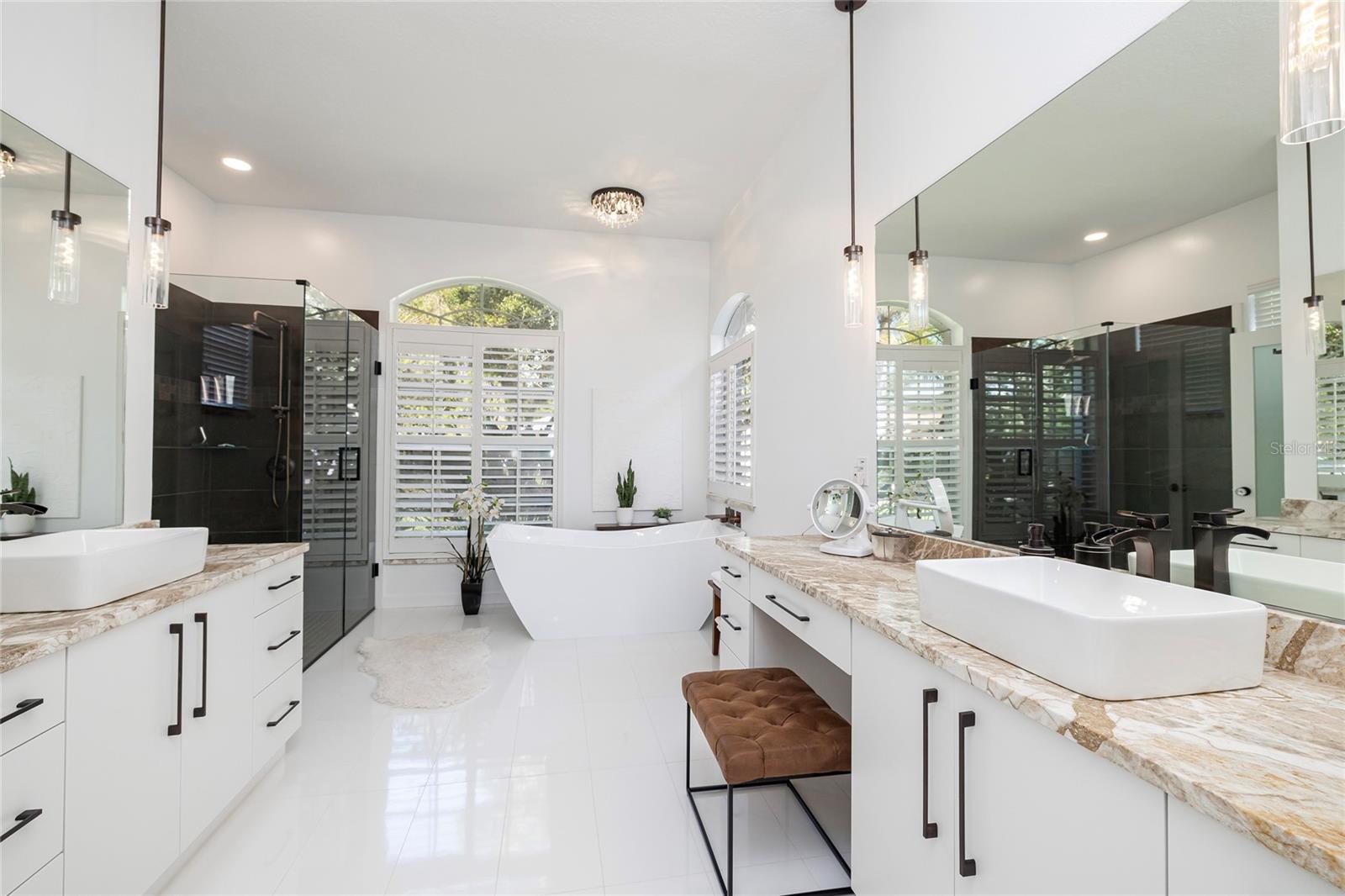 Updated primary bath with beautiful walk in shower and stand alone tub