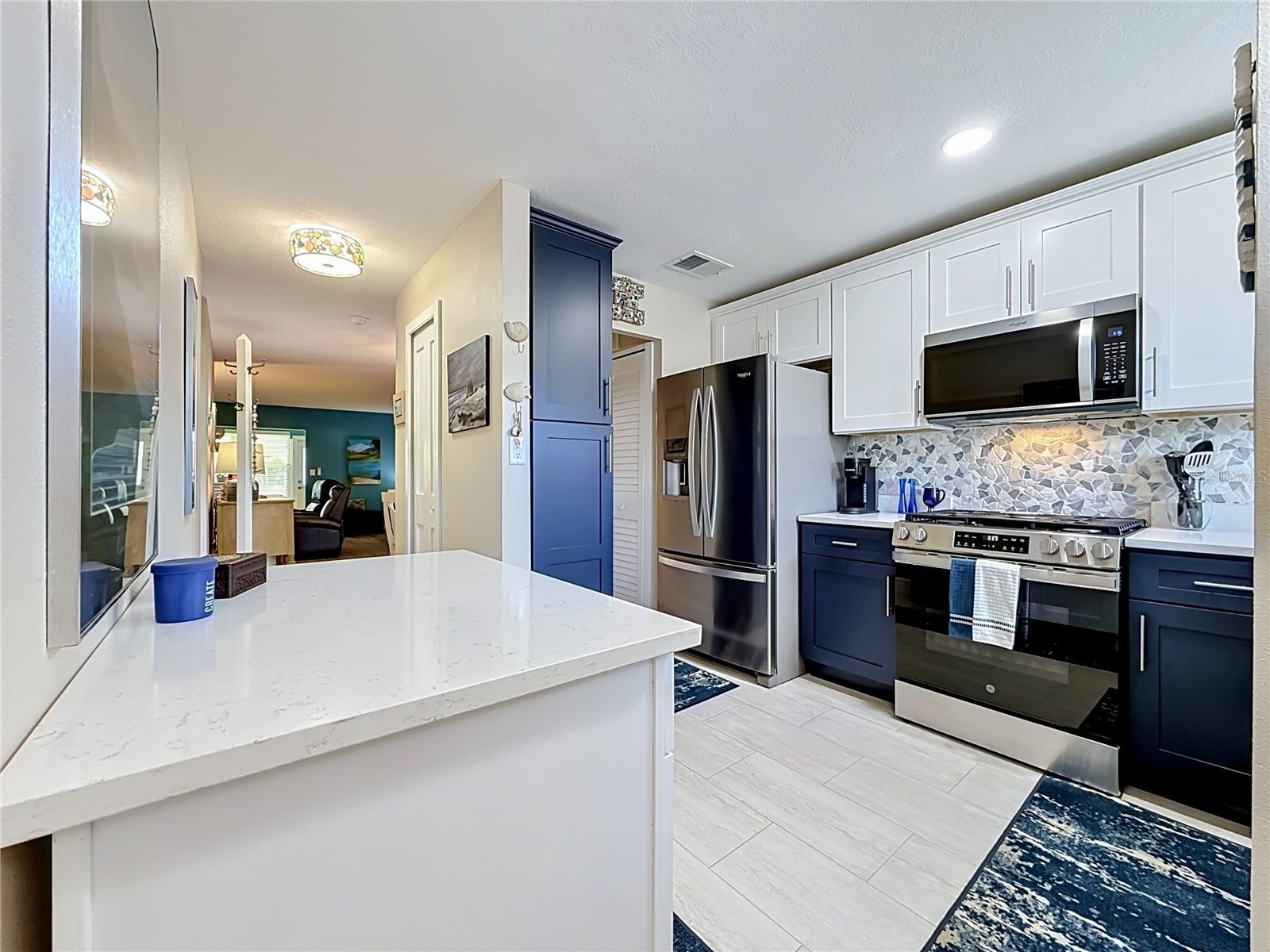 Kitchen with new quartz counter tops, cabinetry and appliances