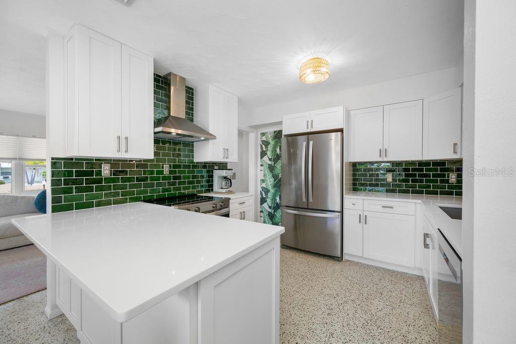 This Kitchen is a Showstopper - Brand New Cabinets, Quartz Countertops, Emerald Green Spanish Tile Backsplash, All Appliances are Brand New (with the exception of the Refrigerator)