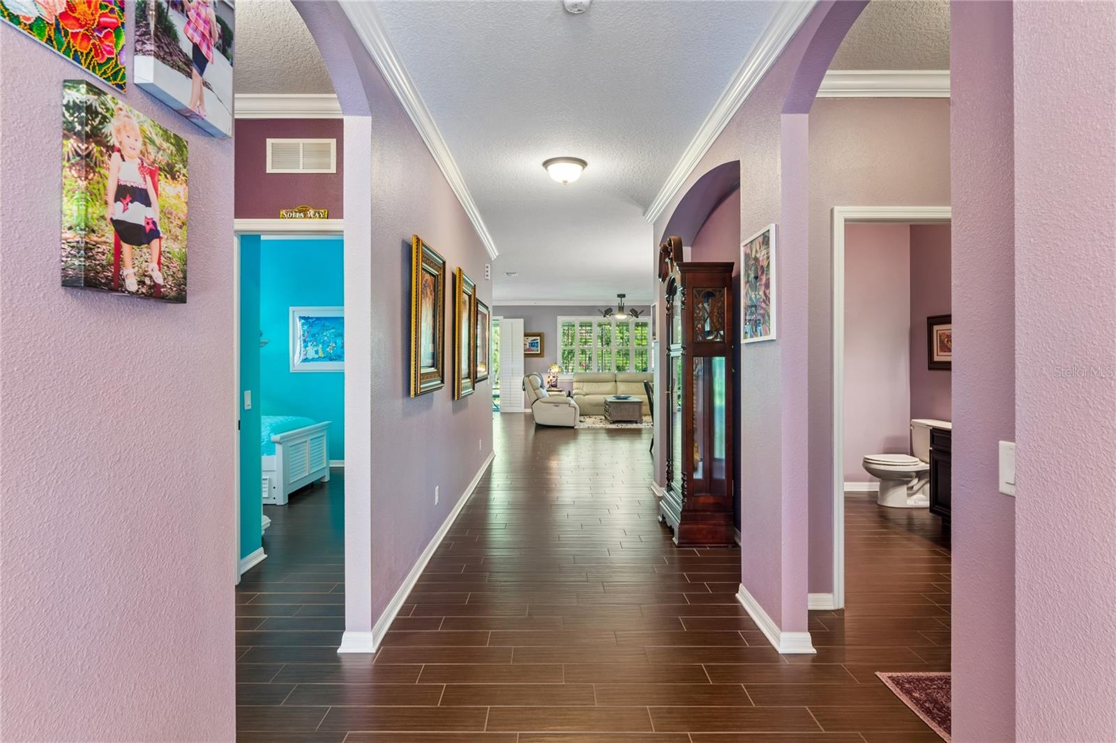 View of the Home from the Front Door. Two Bedrooms and a Full Bath are to the Left. Den/Flex Room to the Right. A Separate Hallway to the Laundry Room and Half-Bath Keep the Sleeping Quarters Private and Quiet.