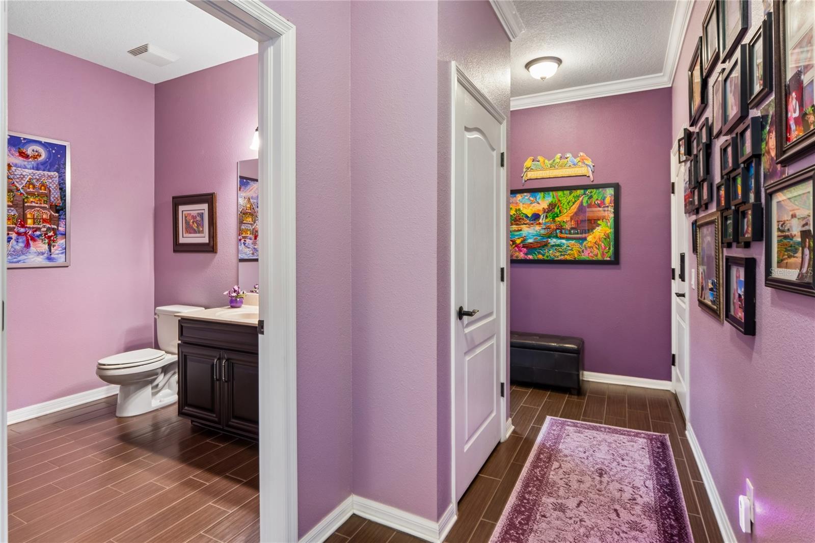 Hallway leading to the half bath and laundry room