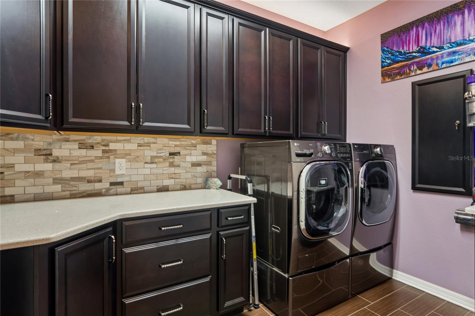Gorgeous Backsplash and Custom Cabinetry Make Laundry More Enjoyable