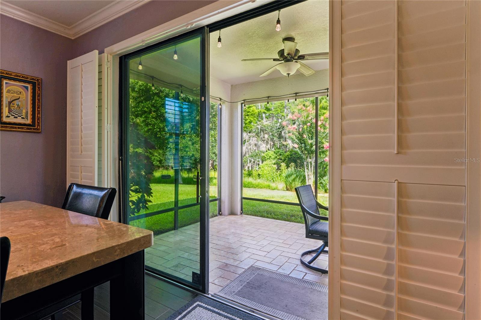 Bring the Outside in, with the Open Feel of a Slider from the Kitchen/Living Space. Plantation Shutters allow you to adjust the lighting and privacy any time of day or night.
