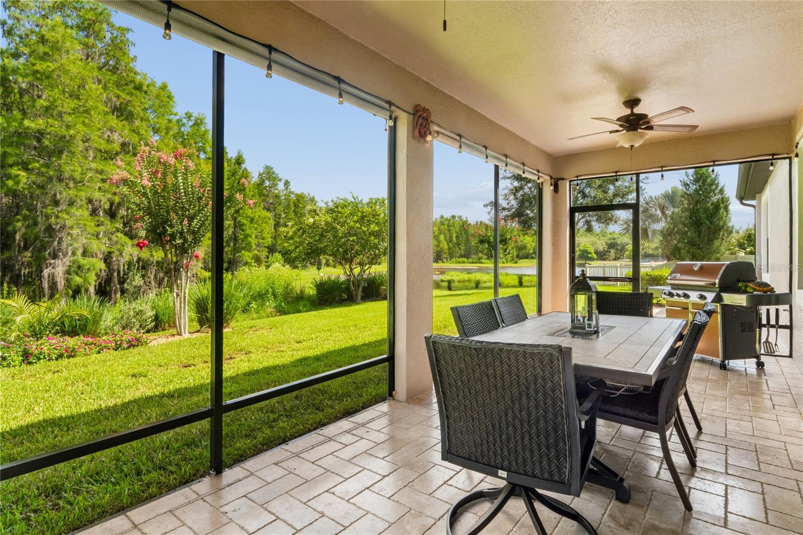 Screened in Patio with Pavers (additional pavers on site) Patio Furniture and Grill Come with the Home!