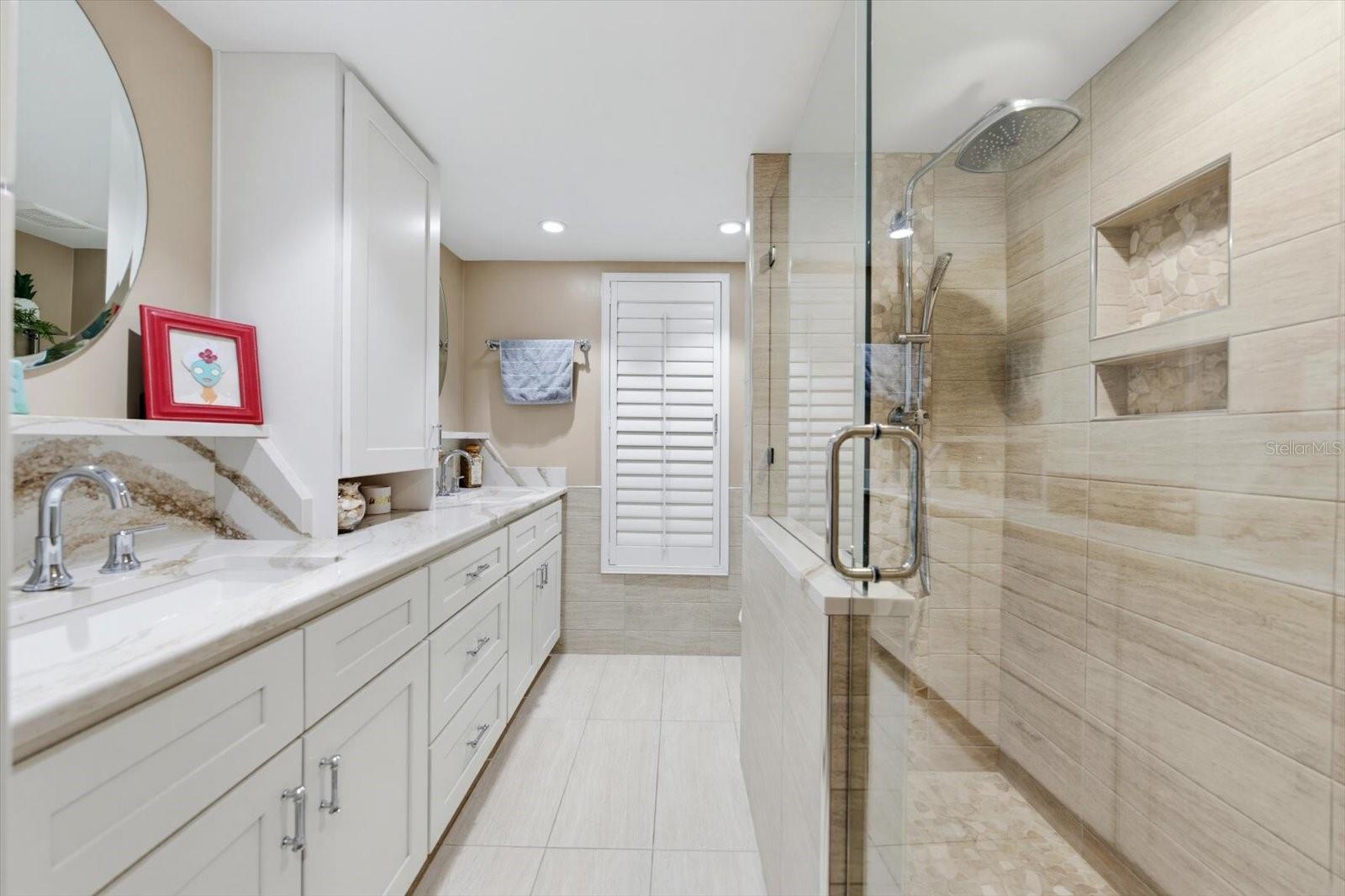 Guest Bathroom 1 with double vanites that also leads out to the pool area