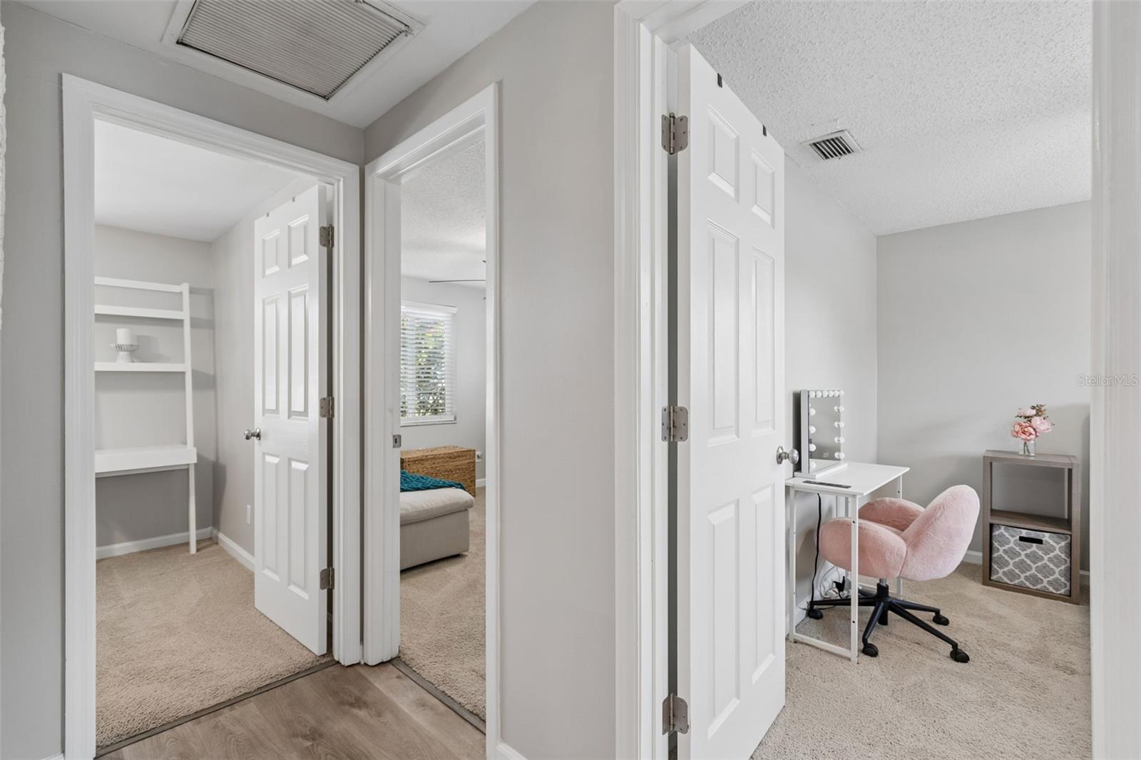 Hallway glimpses into the three beautiful bedrooms located on the northside of the home.