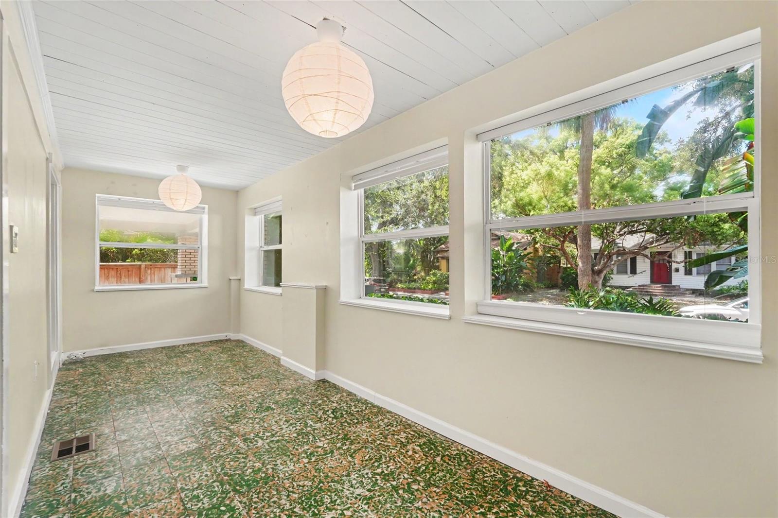 One of the home’s most distinctive spaces, the enclosed front porch features original Cuban tile and endless possibilities for relaxing, reading, or entertaining.