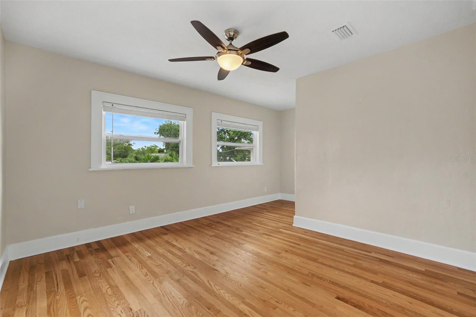The bedroom offers hardwood floors, abundant natural light, and plenty of room to create a comfortable retreat.