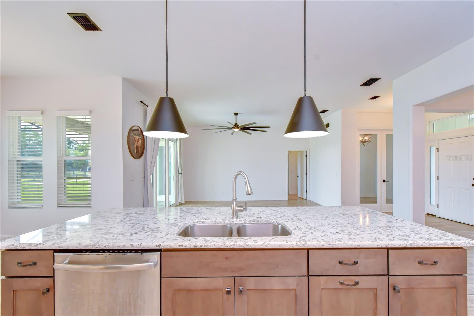 Large center island with double sink and ample prep space.