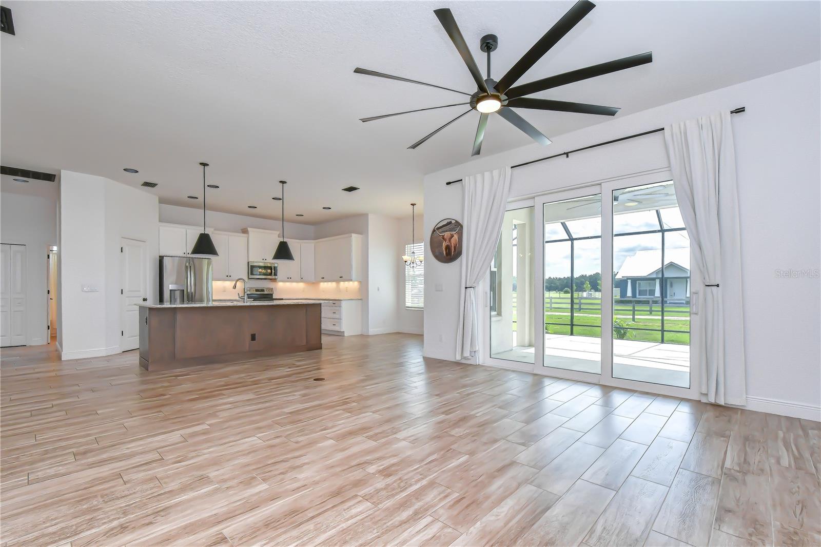 Expansive gathering space with picturesque backyard views.