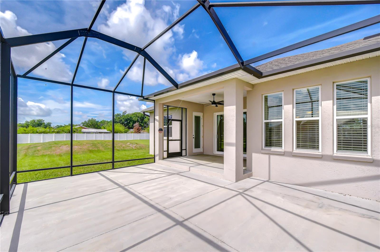 Covered screened lanai overlooking the expansive backyard.
