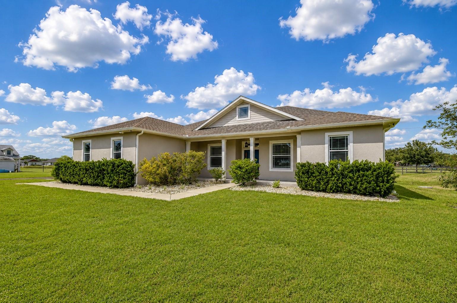 Charming architectural design with welcoming front porch and timeless curb appeal.