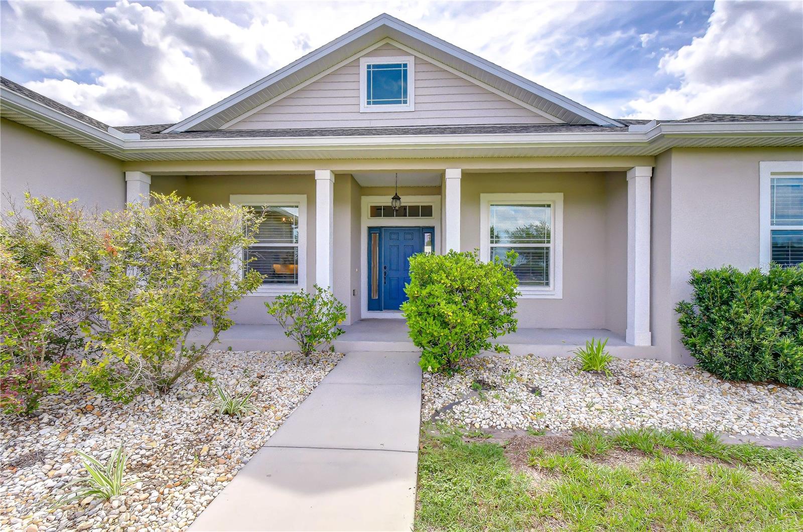 Inviting covered porch perfect for rocking chairs and enjoying peaceful country views.