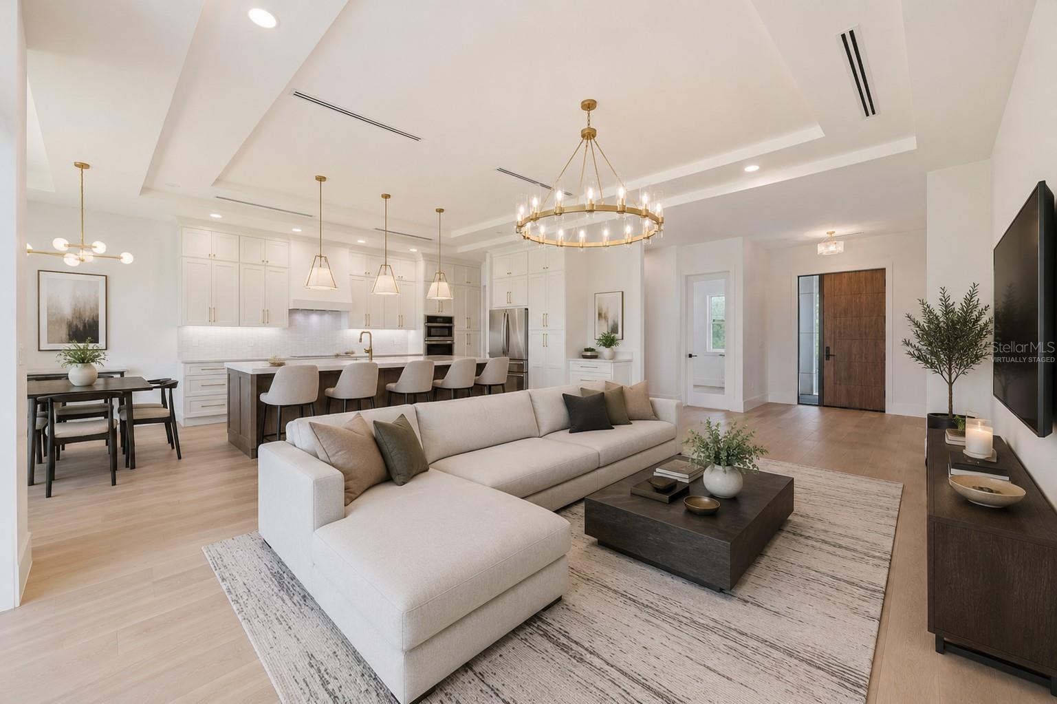 Virtually staged.Living Room / Kitchen / Dining area/ Front door.