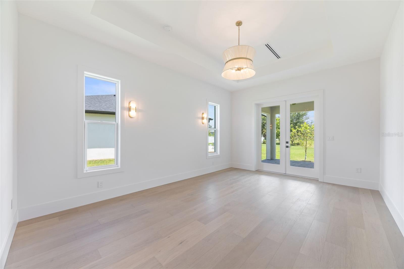 The luxurious primary suite offers a spa-inspired retreat featuring a freestanding soaking tub, oversized walk-in shower with rain head and handheld shower, premium Italian tile, designer fixtures, and thoughtful custom details throughout.