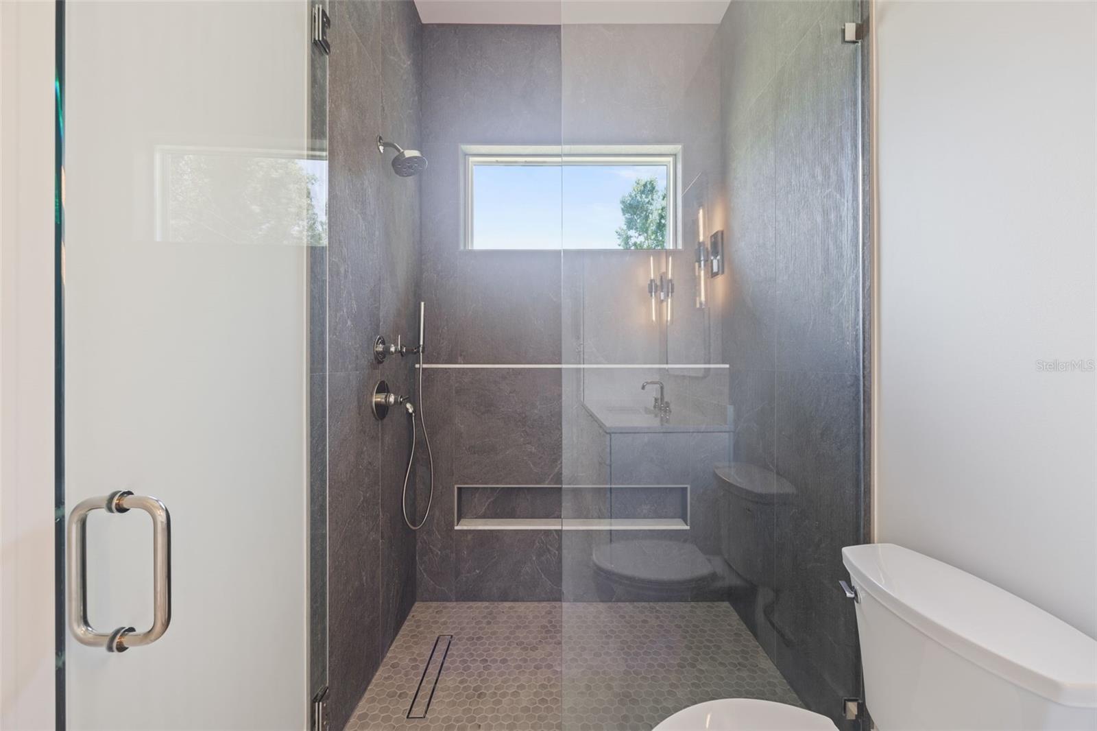 Bedroom 3 enjoys a private en-suite bath with direct exterior access to the lanai, providing an ideal guest retreat and future pool bath.