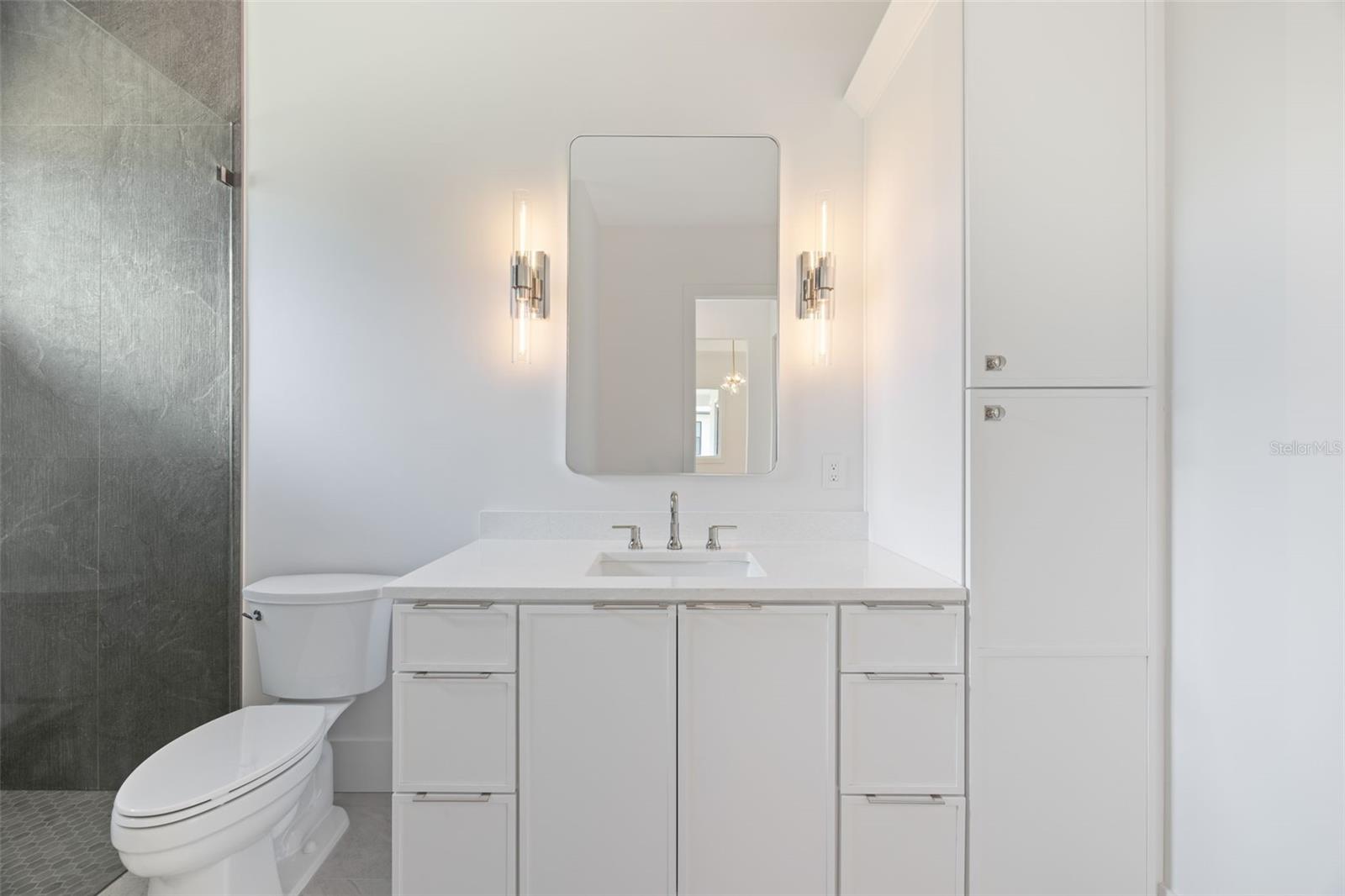Bedroom 3 enjoys a private en-suite bath with direct exterior access to the lanai, providing an ideal guest retreat and future pool bath.