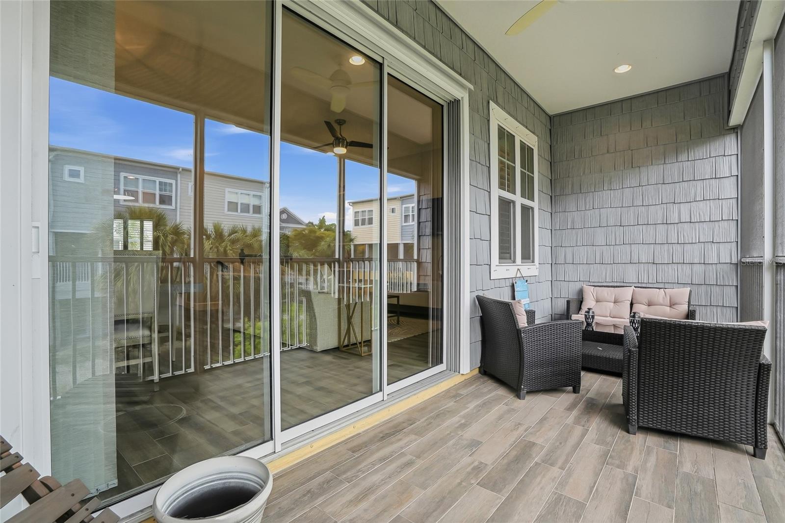 Spacious covered terrace with sliding glass doors, perfect for relaxing or entertaining right off the living area.