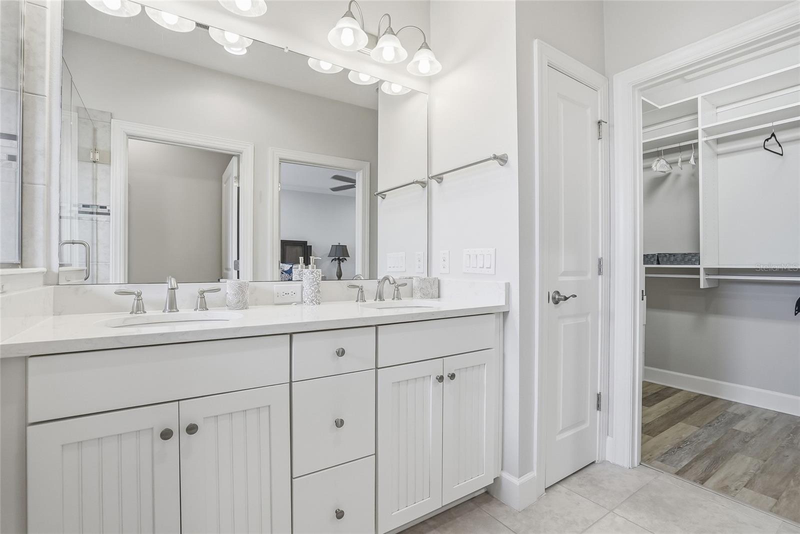 Primary bathroom with double sink and extra large walk in closet