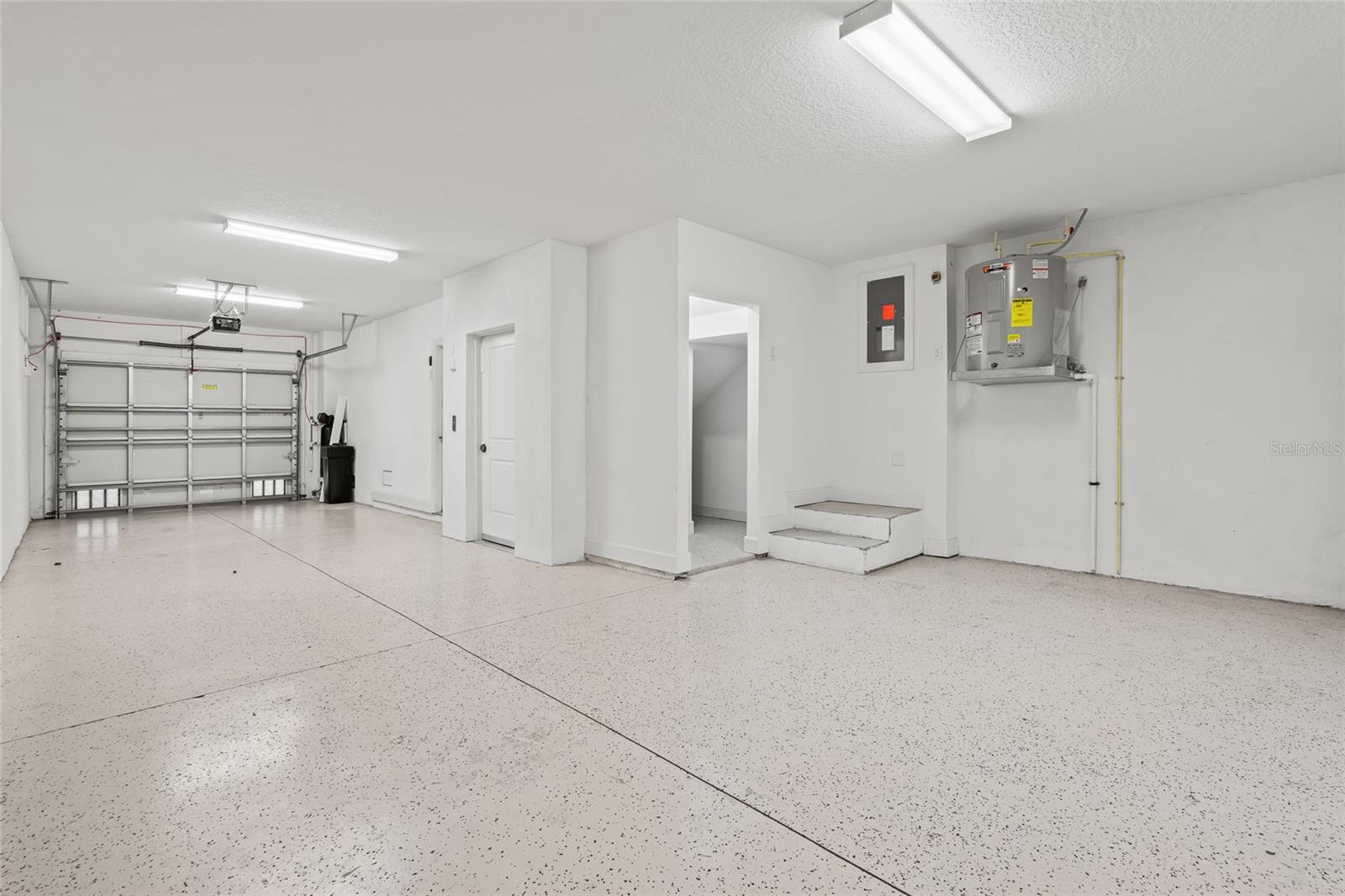 Extended 2 car tandem garage with storage room and upgraded flooring