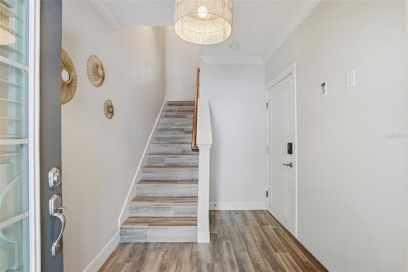 First floor foyer. To the right is the door to the expansive two-car garage and elevator.