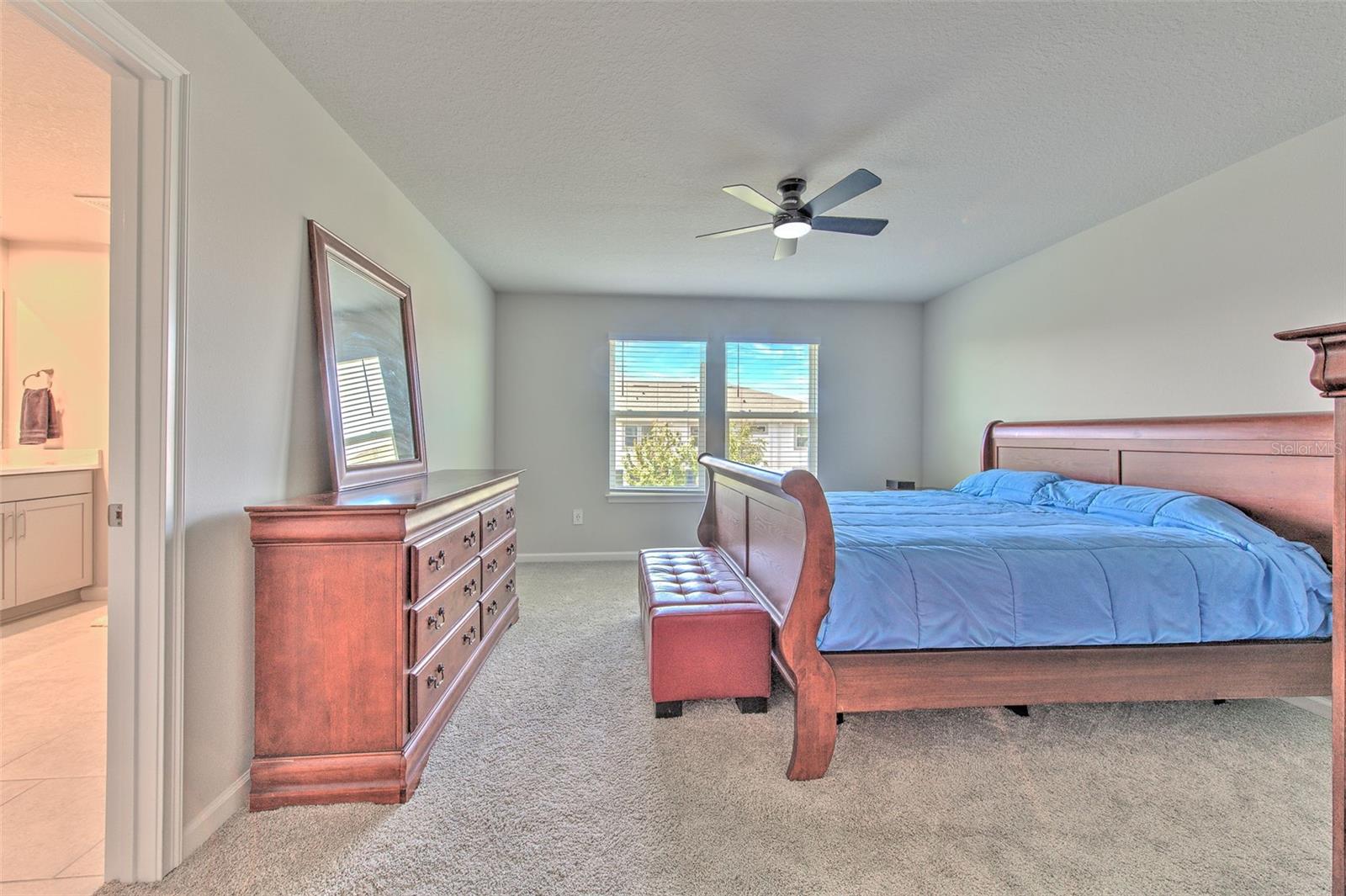 Owner's Suite with Ceiling Fan and Water View
