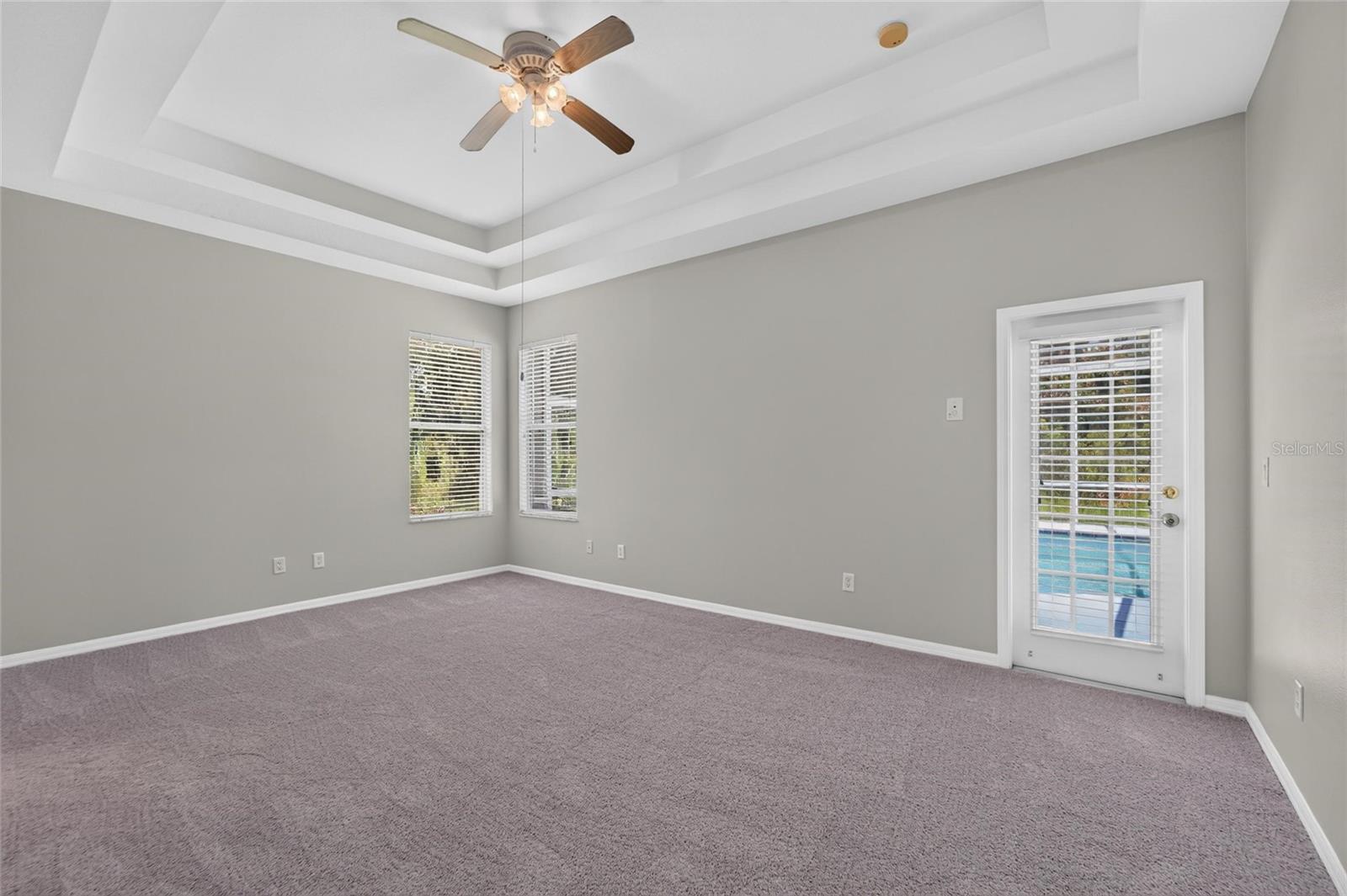owners suite with pool door, new paint and carpet