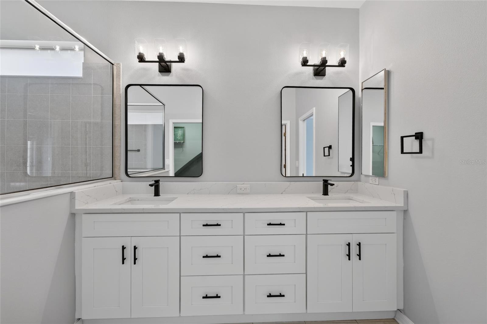 Brand new shaker cabinets, quartz countertops, mirrors and hardware