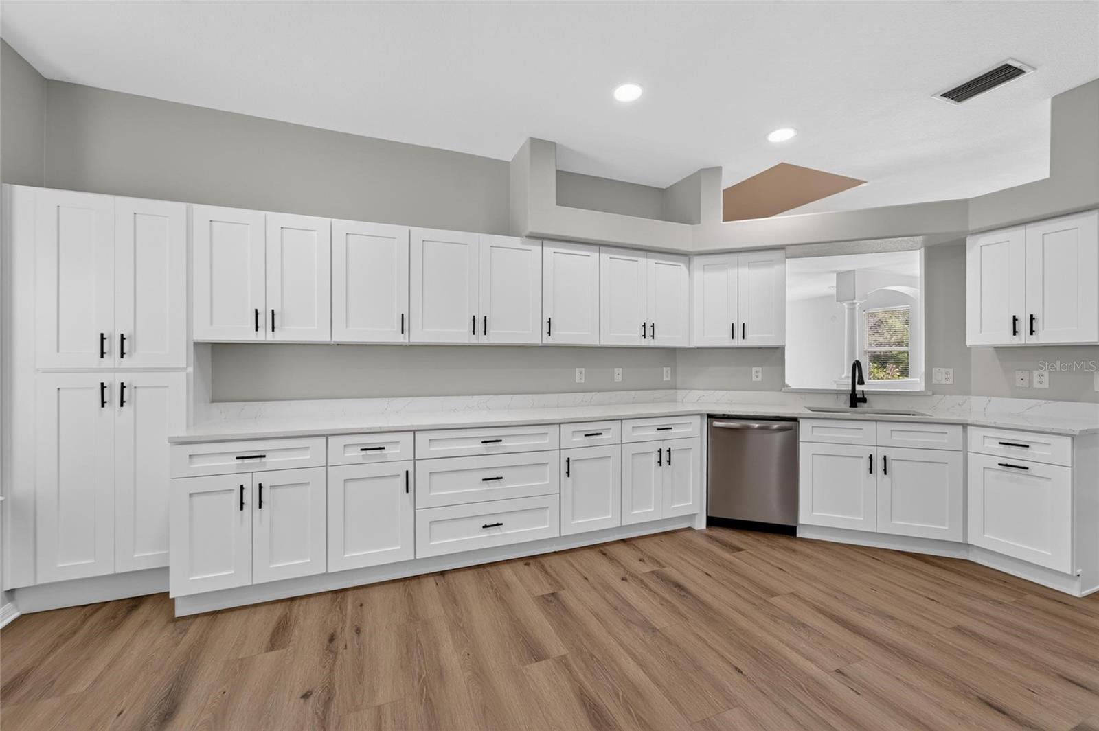 Kitchen remodel with plethora of cabinets and quartz countertops