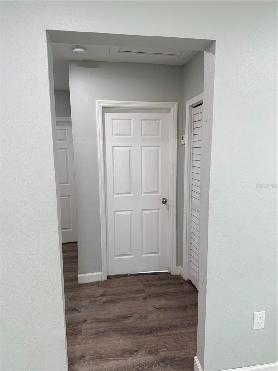 Primary bedroom with thermostat conveniently located right outside the door.