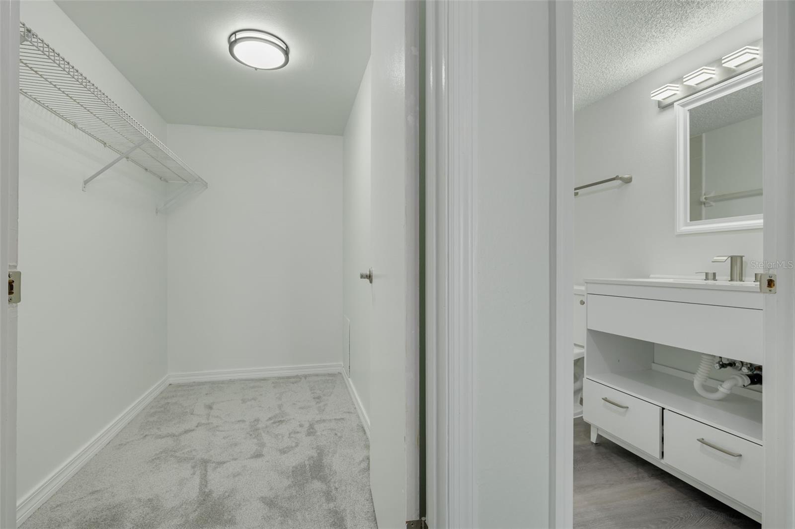 Primary bedroom walk in closet