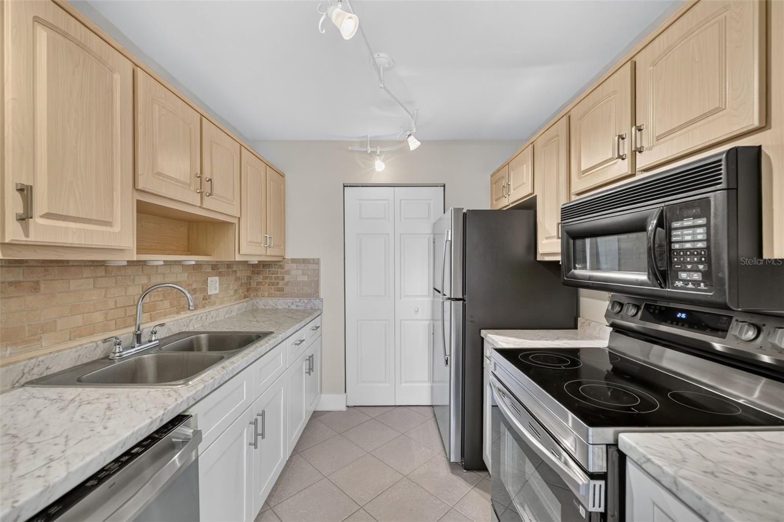 Kitchen area with stainless steel appliances and Laundry room