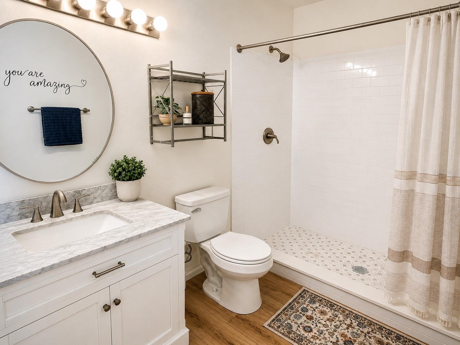 Owner’s Bathroom – Updated owner’s bathroom with a walk-in shower and modern finishes.