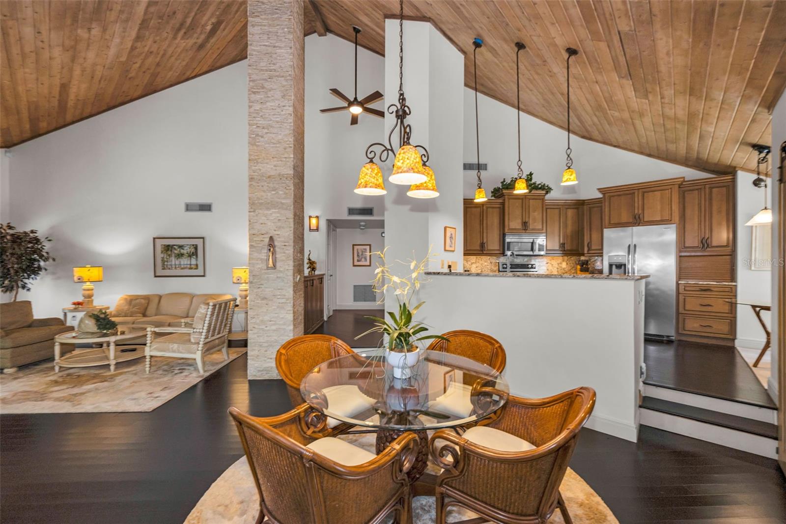 Living room, formal dining and the beautiful kitchen! Note the tongue and groove vaulted ceiling and the stacked stone details!  It's a lovely home!