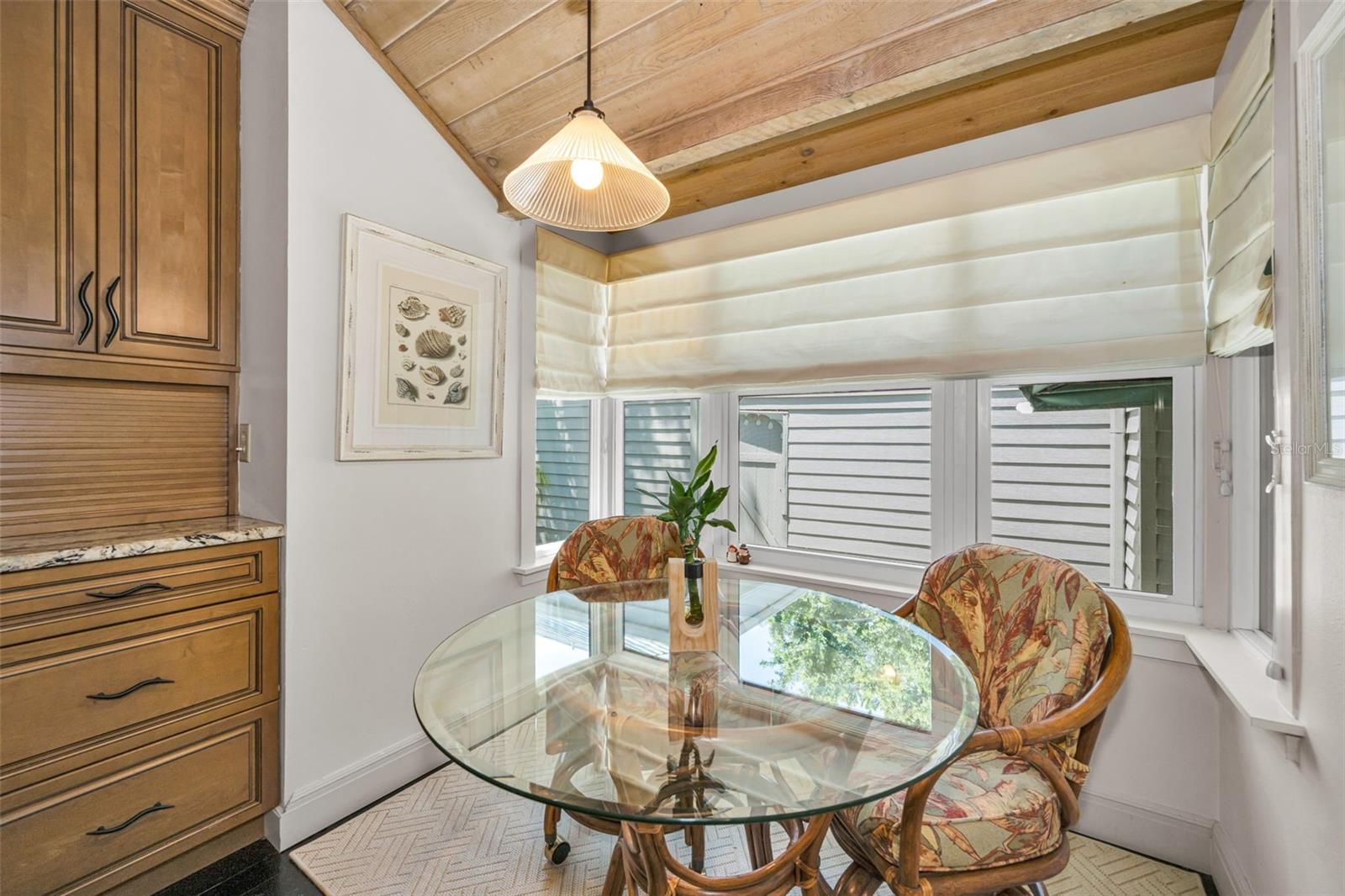 Breakfast nook and garden window with roman shades.