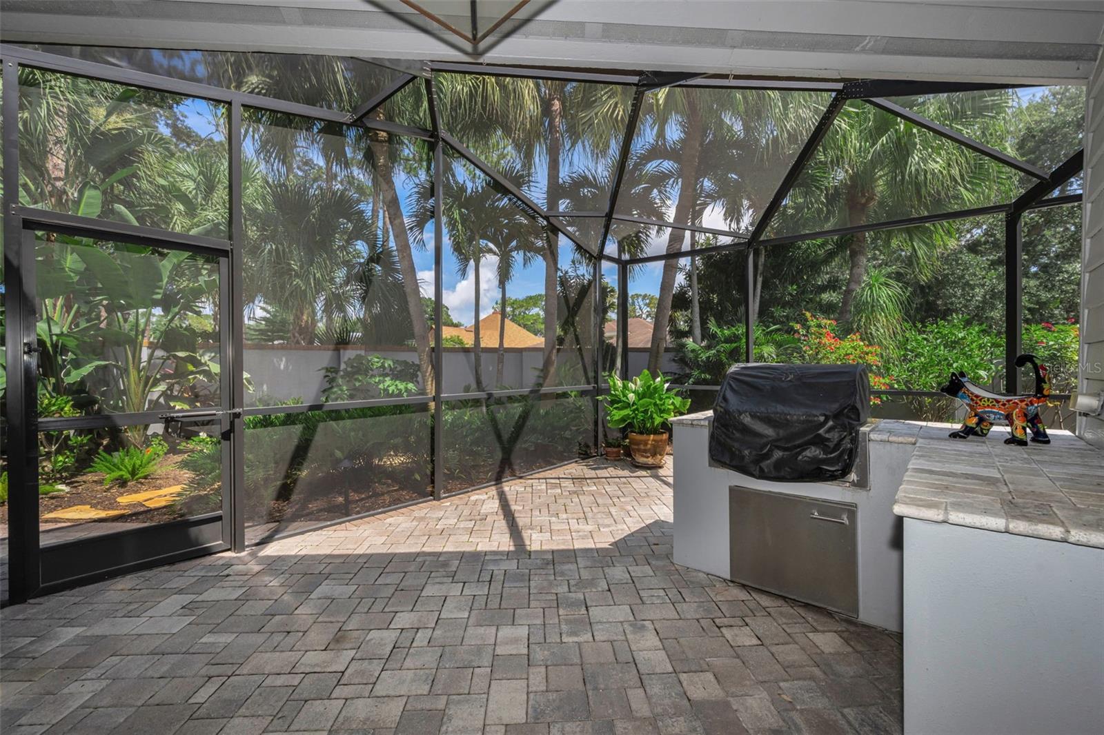 Coming from the living room to the screened patio and grill area, that wraps around to the pond view! So gorgeous for entertaining!