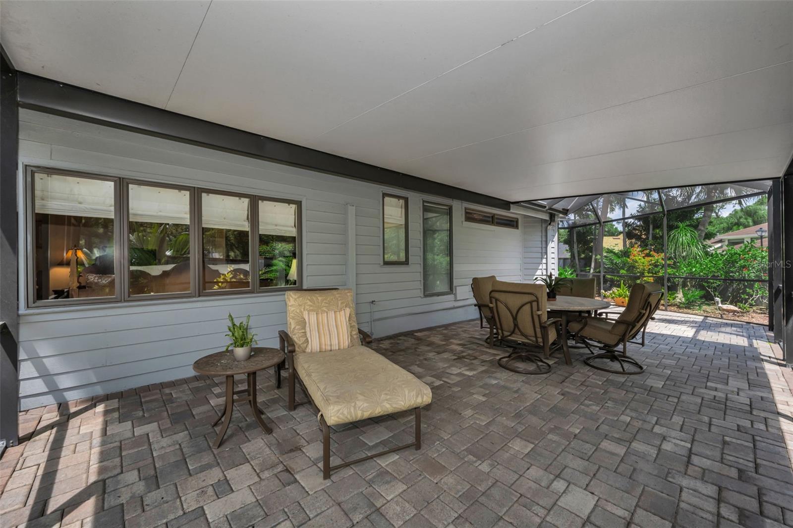 Screened and covered section of the pond side patio. So perfect for reading and chatting with neighbors! Not another home like it in the community!