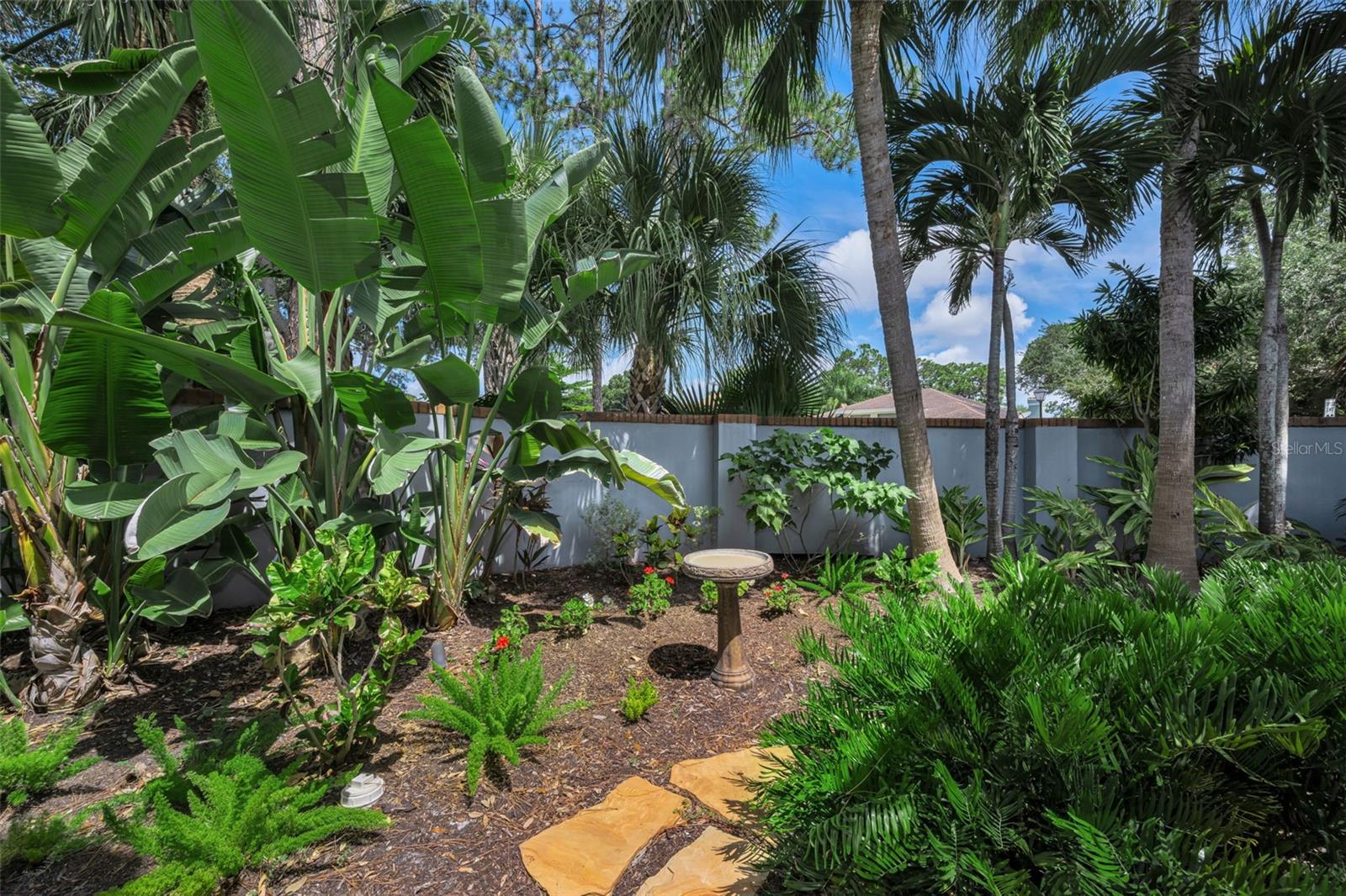 Lush garden area off the living room area and the front screened patio.