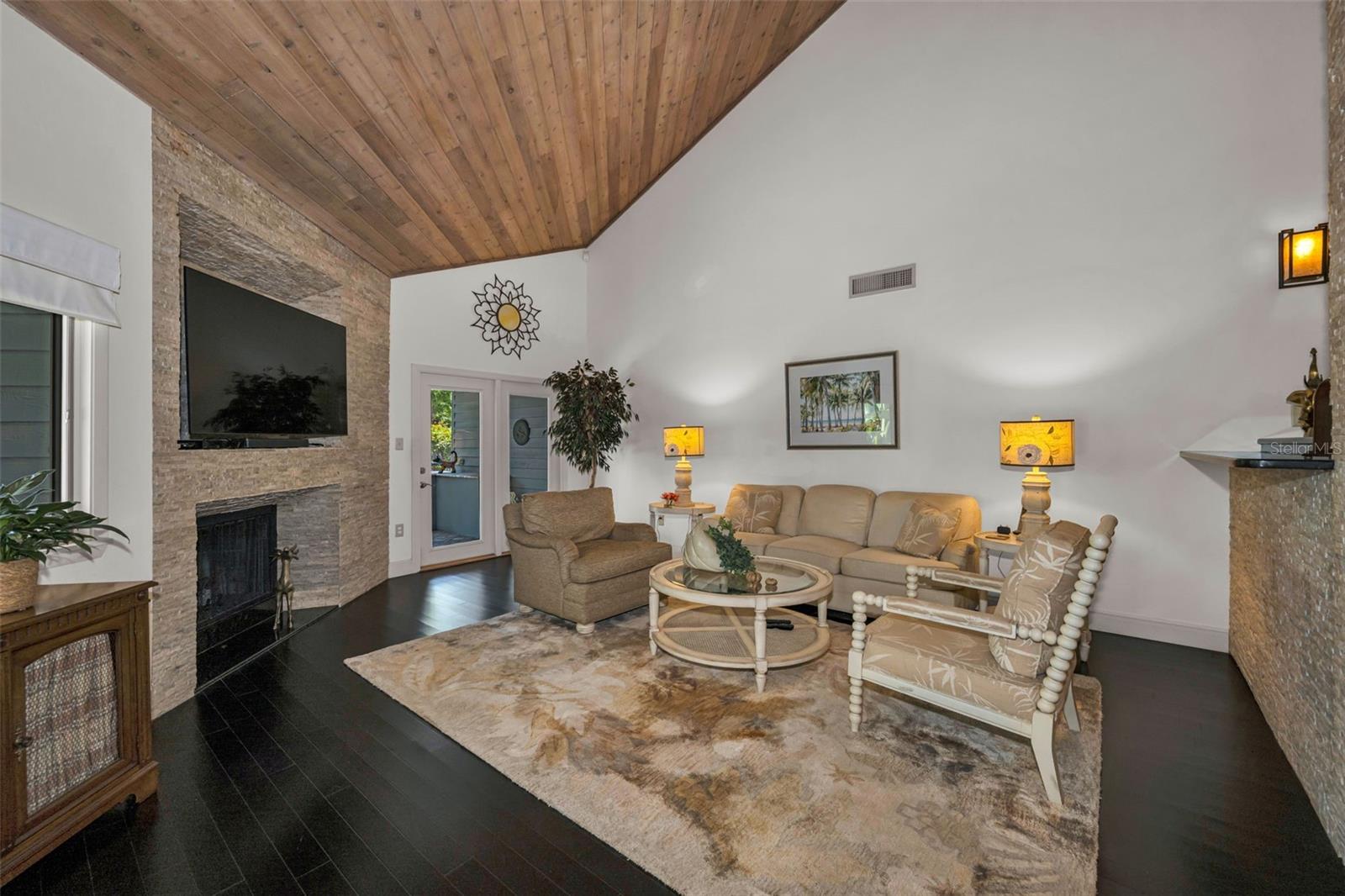 Living room with French doors leading to the pond side patio and grill area!  So perfect for entertaining!