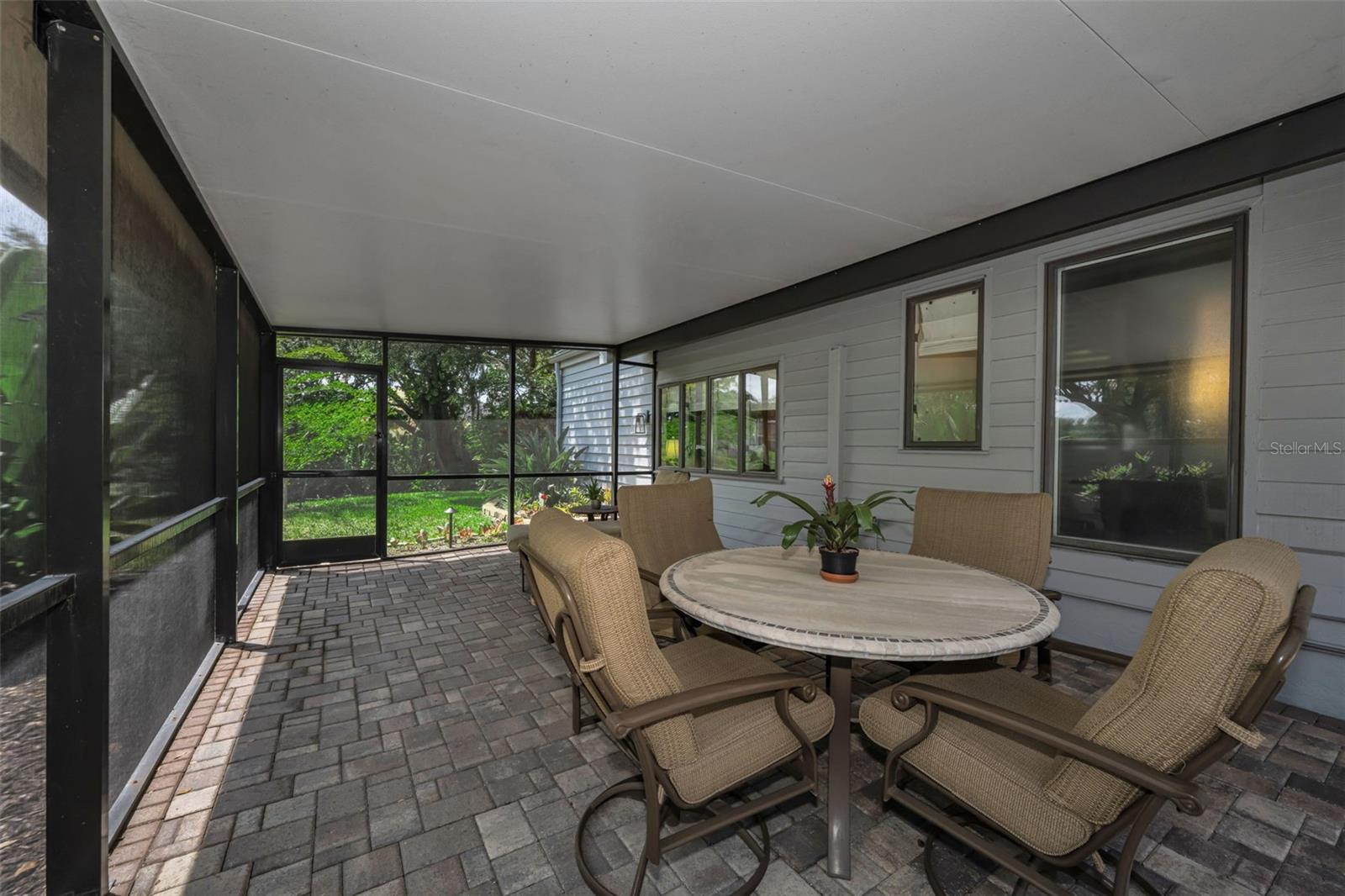 Screened side patio leading to the pond area.