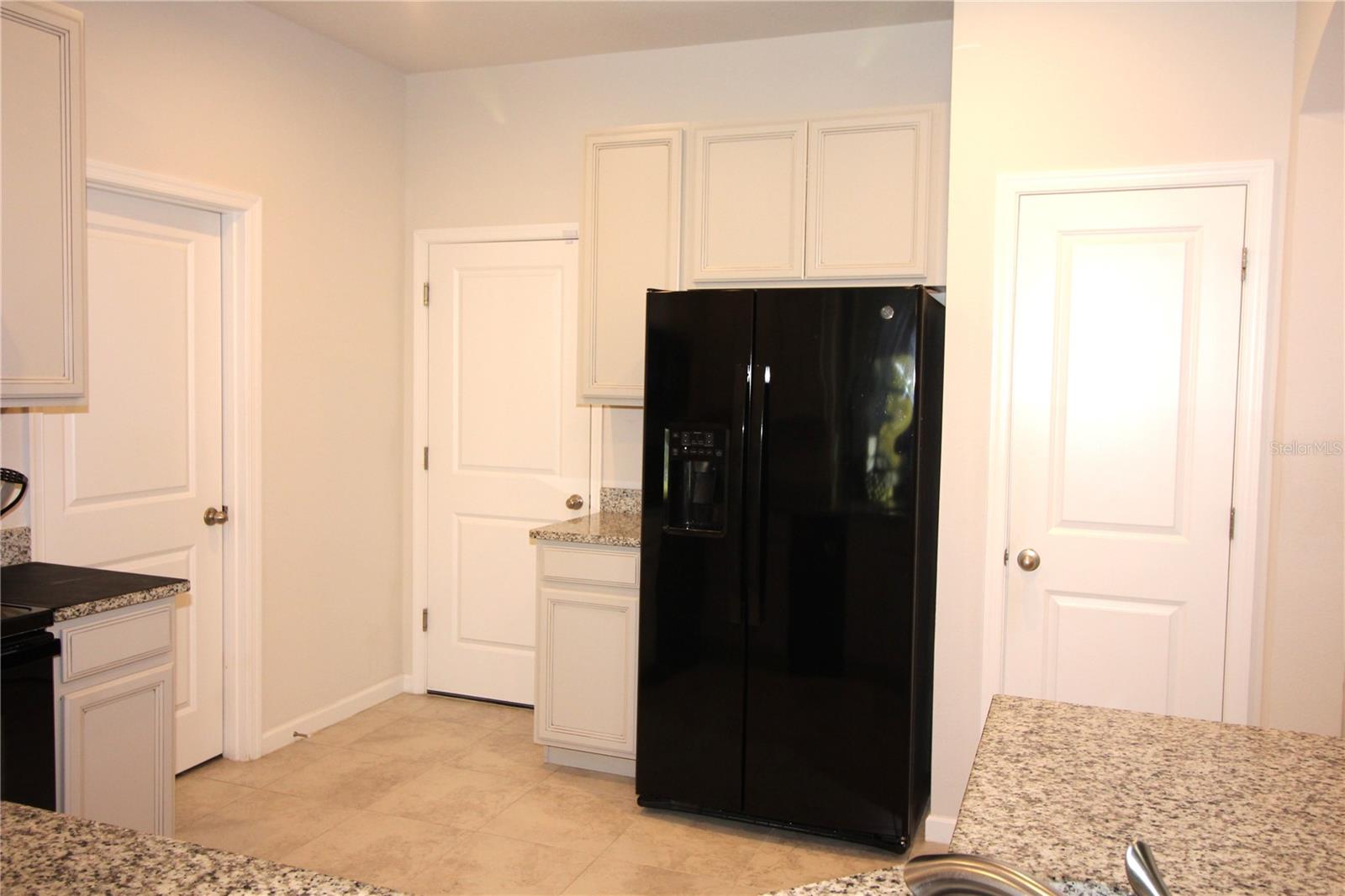 door on far left to laundry, next door is to garage, and door on right is to pantry