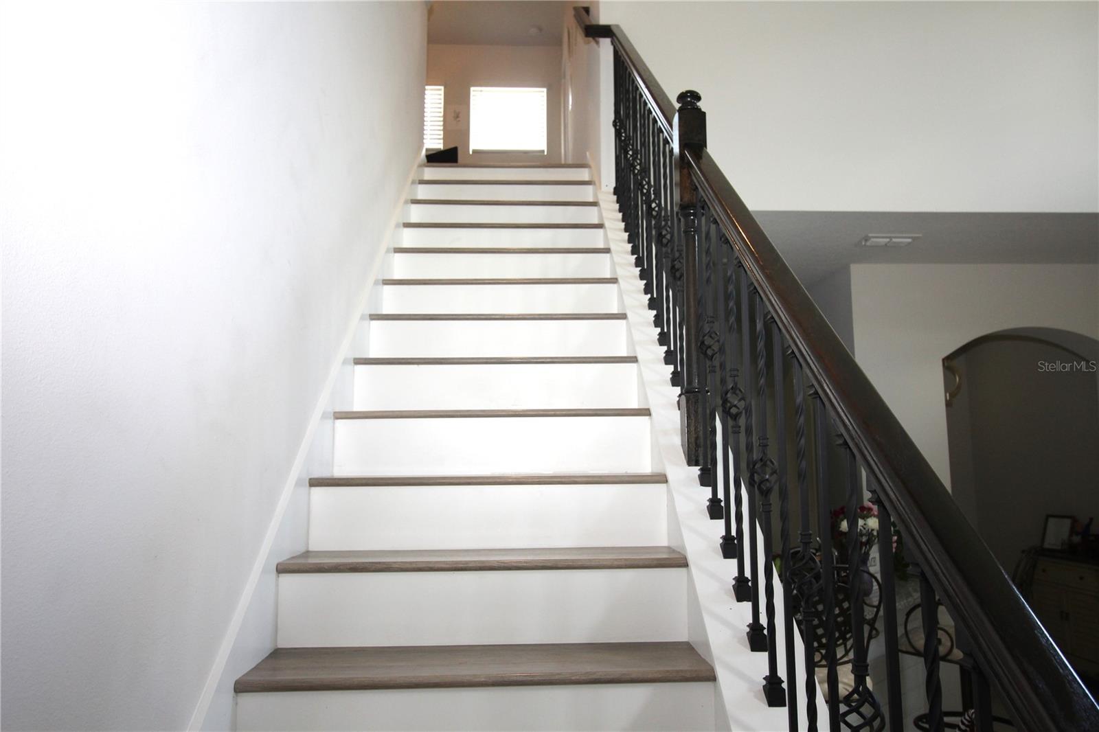 note...vinyl plank flooring and upgraded rod iron stair railing