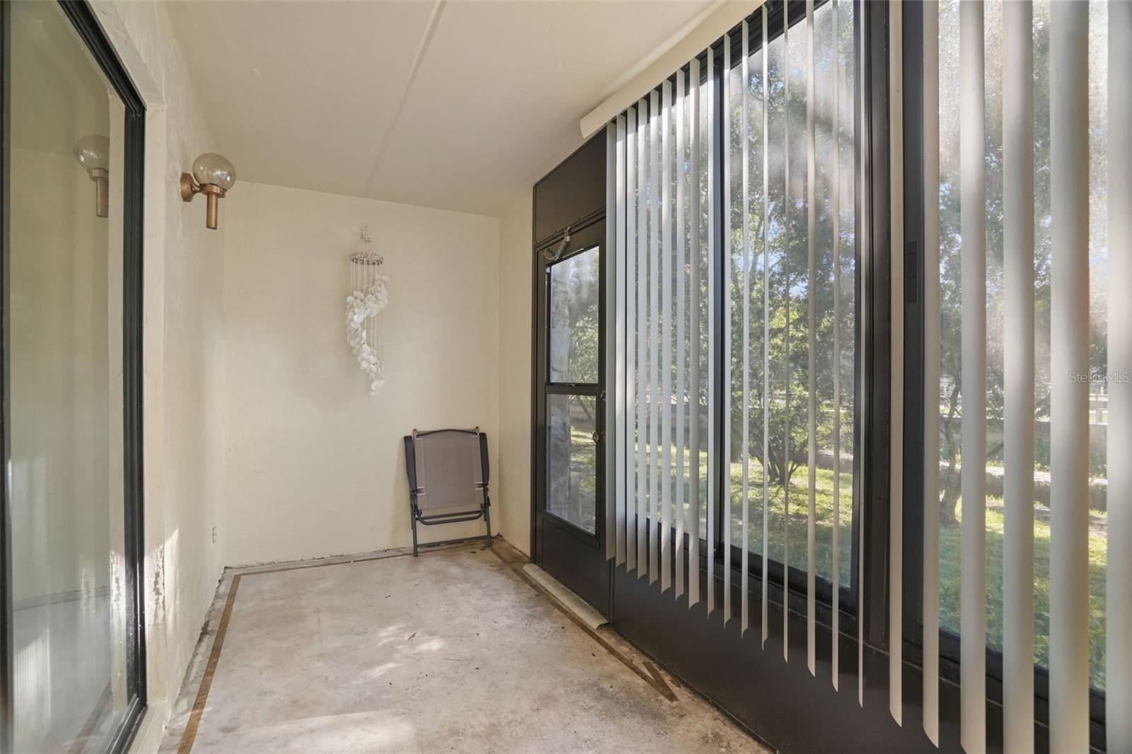 Relax and Unwind. The enclosed screened lanai offers a quiet spot to enjoy your morning coffee, read a book, or simply take in the peaceful, tree-lined view.