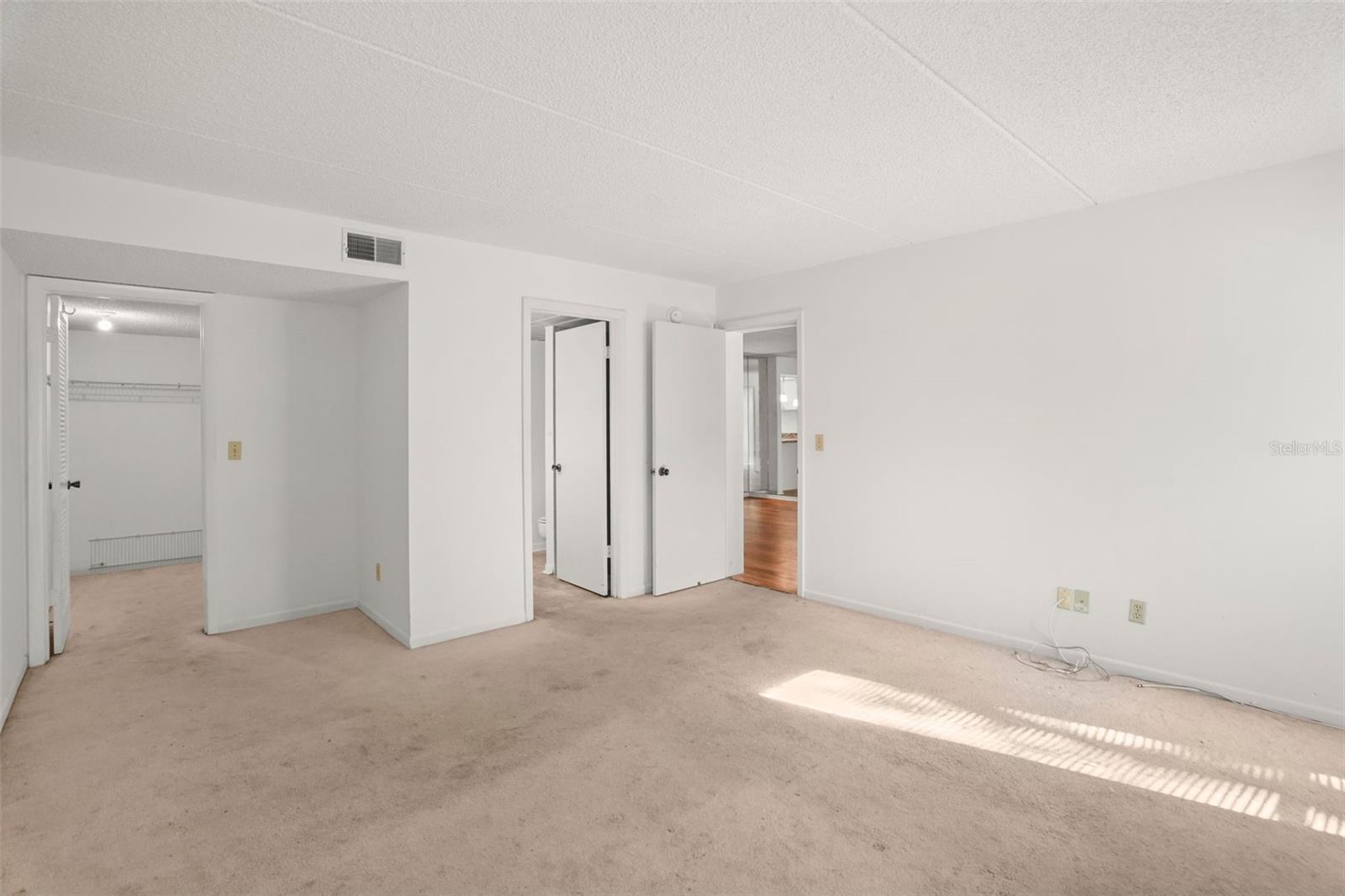 A Comfortable Primary Suite. The spacious bedroom includes a walk-in closet and private en suite bath, creating a layout designed for comfort and convenience.